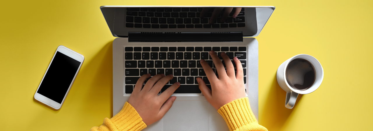 yellow background with laptop, coffee & phone