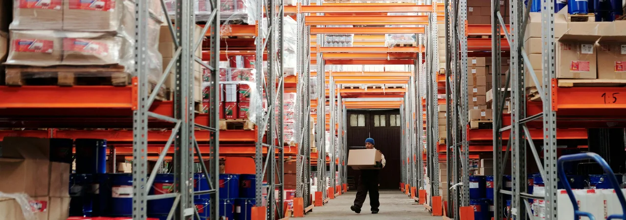 person lifting boxes in a warehouse