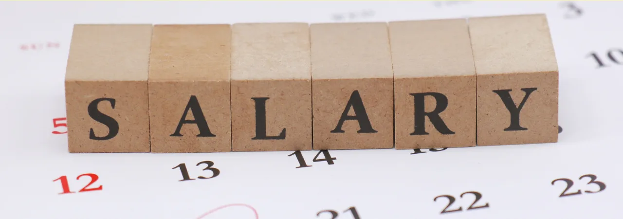 blocks placed on top of a calender with the letters SALARY