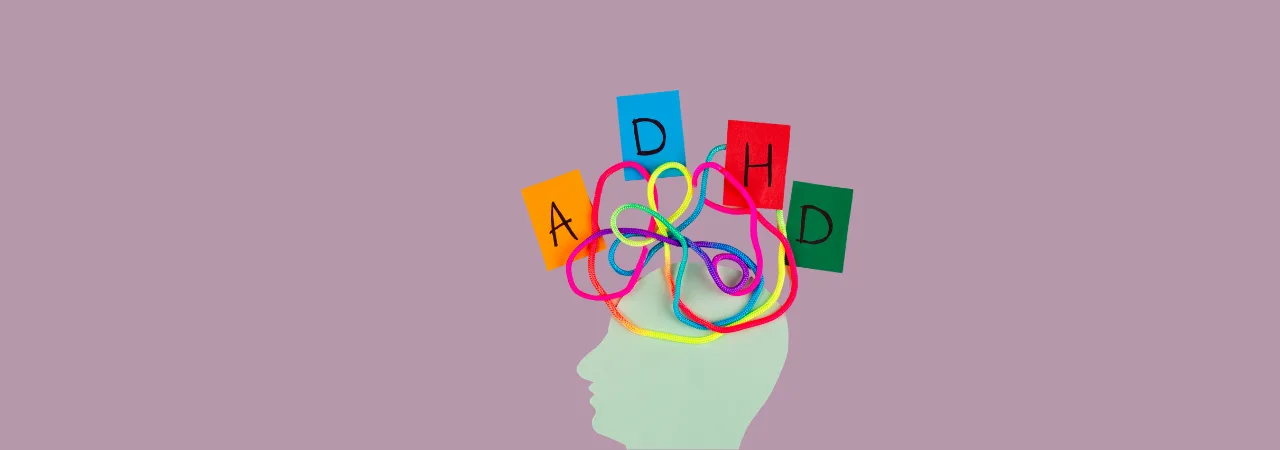 An image of a head figure with a colourful spiral and 4 signs spelling ADHD, A neurodivergent disorder